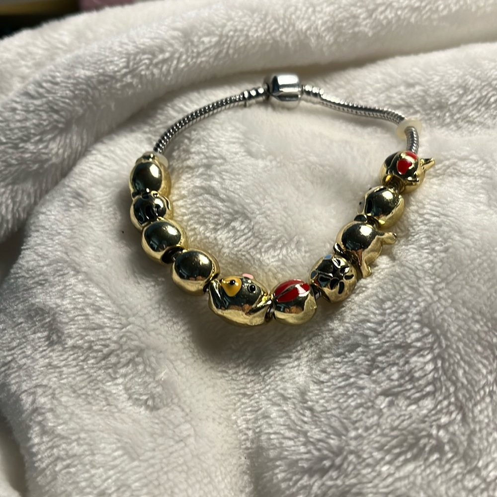 Bracelet, silver with gold 10 balls, faces red blue white unusual so and gold